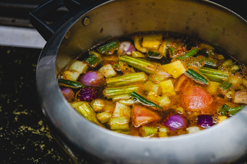 Traditional Indian cookware including kadai, tawa and brass utensils at Om Spice and Sweets