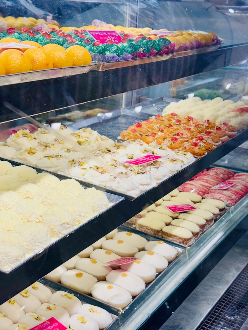 Fresh Indian sweets and mithai including barfi and gulab jamun at Om Spice and Sweets